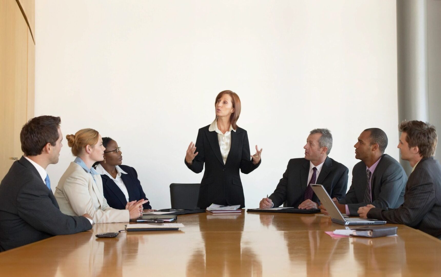 A woman standing in front of a group of people.